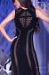 Vestito nero aderente con inserti traforati.